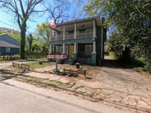 view of front of home with a balcony and covered porch