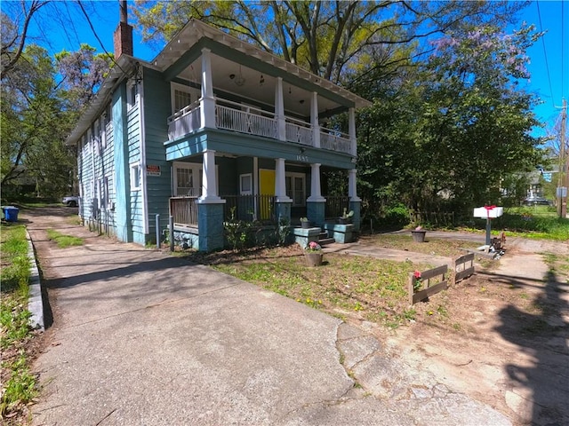 view of front of home with covered porch and a balcony