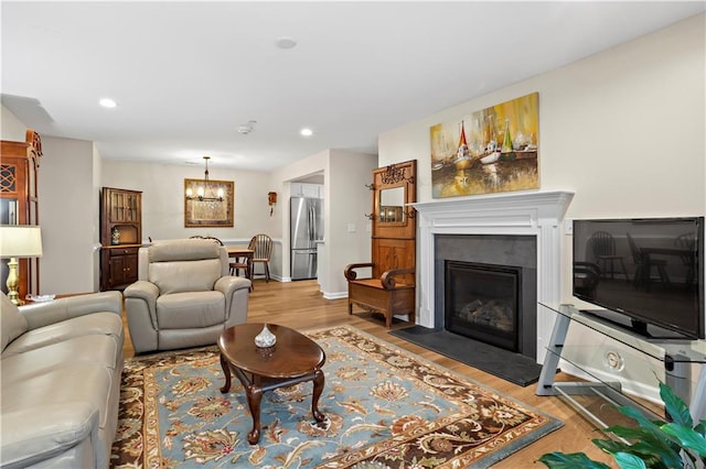 living room featuring a chandelier and light wood-type flooring