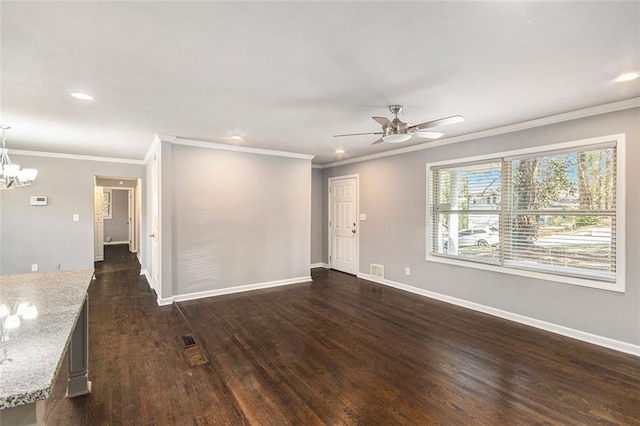 empty room featuring dark wood-style floors, recessed lighting, baseboards, and ceiling fan with notable chandelier