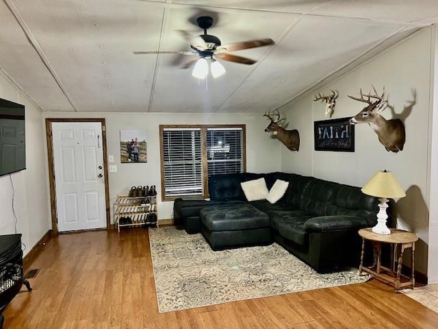 9262 Morrison Rd, Lula, GA 30554 - living area with ceiling fan, wood finished floors, and vaulted ceiling