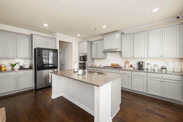 kitchen with light stone counters, ornamental molding, stainless steel appliances, sink, and dark hardwood / wood-style floors