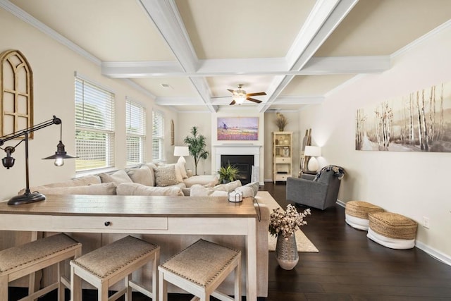 living room featuring ornamental molding, coffered ceiling, ceiling fan, beamed ceiling, and hardwood / wood-style floors