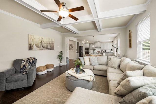 living room featuring coffered ceiling, ceiling fan, crown molding, dark wood-type flooring, and beamed ceiling