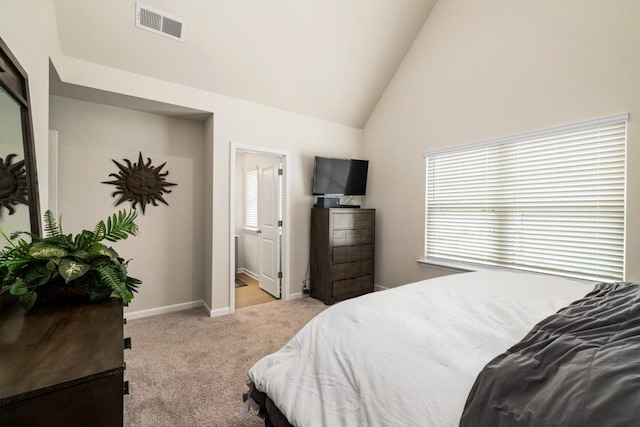 carpeted bedroom featuring connected bathroom and high vaulted ceiling