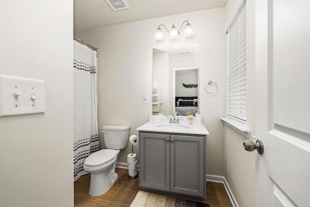 bathroom with radiator, hardwood / wood-style floors, vanity, and toilet