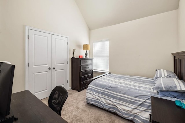 bedroom featuring light carpet, high vaulted ceiling, and a closet