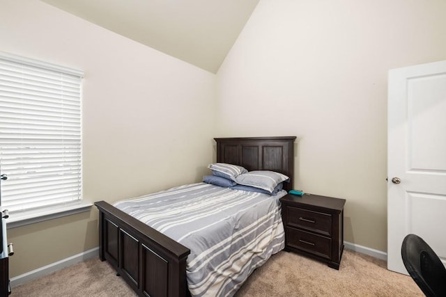 carpeted bedroom with lofted ceiling