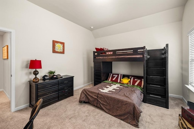 carpeted bedroom featuring vaulted ceiling