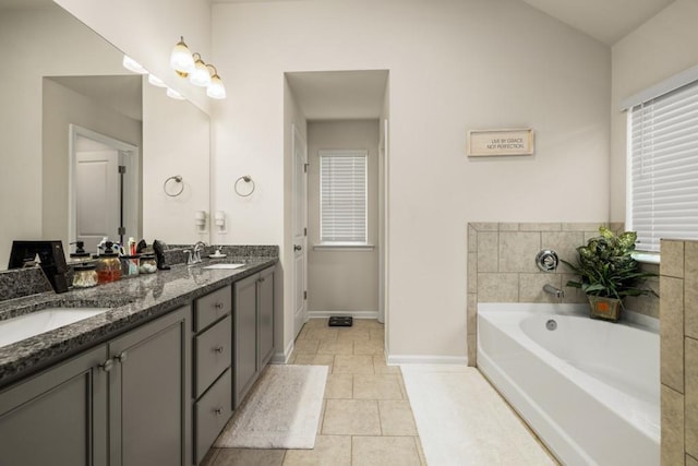 bathroom with tile patterned flooring, vanity, and a bathtub