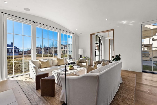 living room featuring hardwood / wood-style floors and vaulted ceiling