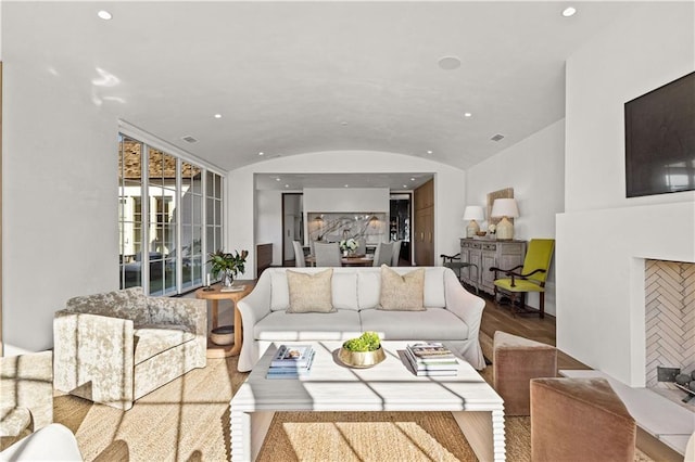 living room featuring lofted ceiling and hardwood / wood-style flooring