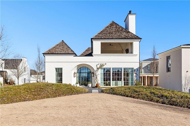 back of property featuring ceiling fan