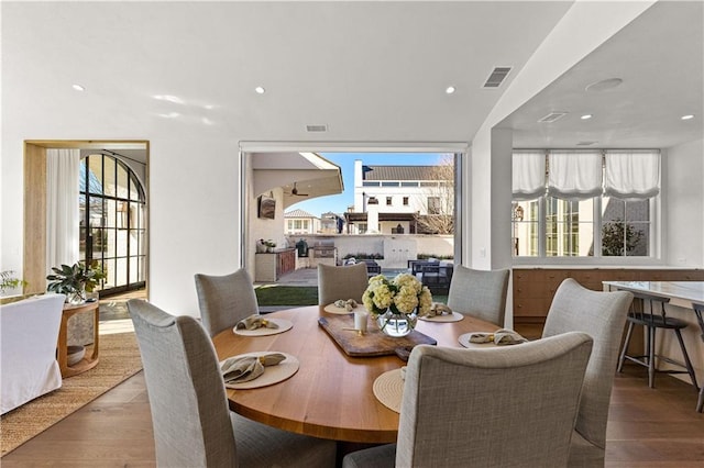 dining room with a healthy amount of sunlight and hardwood / wood-style floors