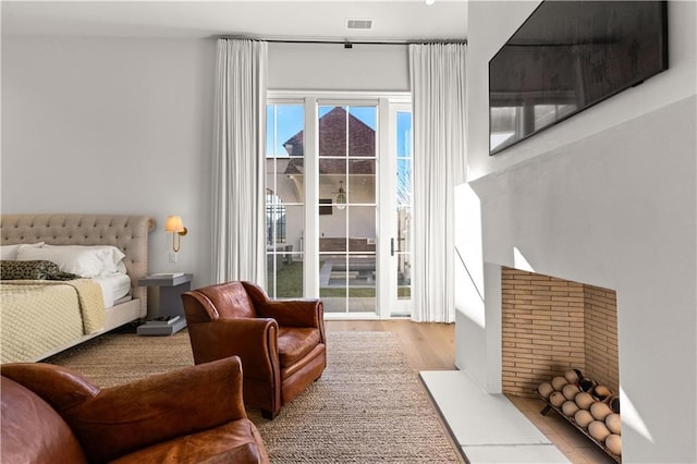 bedroom featuring access to exterior and light hardwood / wood-style floors