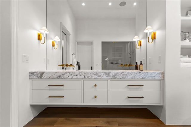 bathroom with vanity, hardwood / wood-style floors, and walk in shower