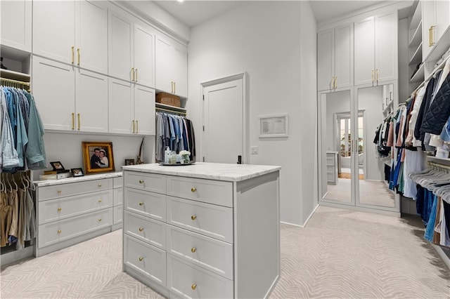 walk in closet featuring light colored carpet and french doors