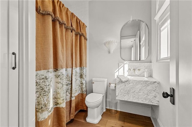 bathroom with a shower with curtain, wood-type flooring, toilet, and vanity