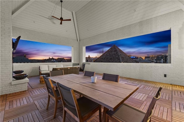 patio terrace at dusk featuring outdoor lounge area and ceiling fan