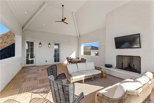 view of patio / terrace with an outdoor living space with a fireplace and ceiling fan