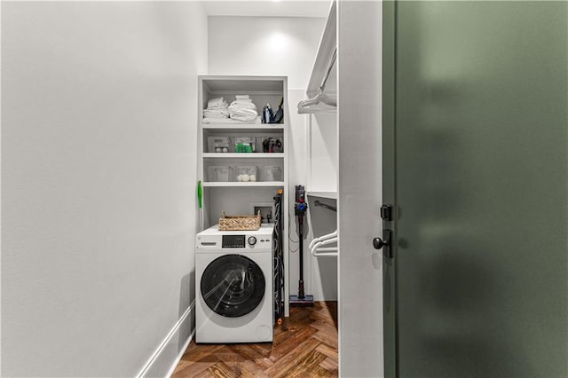 laundry room featuring washer / clothes dryer and dark parquet flooring