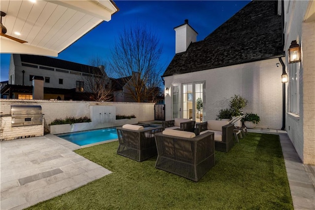 view of pool with area for grilling, a lawn, an outdoor hangout area, exterior kitchen, and a patio