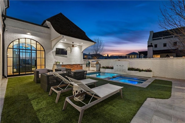 view of pool with an in ground hot tub, a yard, an outdoor hangout area, and a patio area