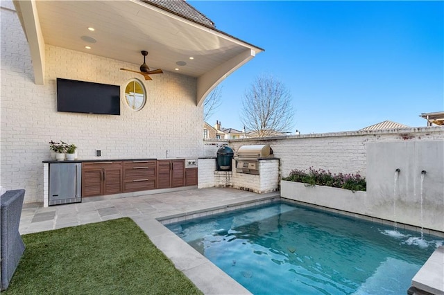 view of swimming pool featuring ceiling fan, area for grilling, and a patio area