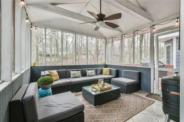 sunroom / solarium featuring lofted ceiling with beams and ceiling fan