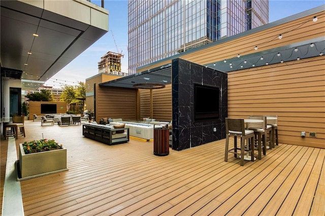 wooden deck with an outdoor hangout area and an outdoor bar