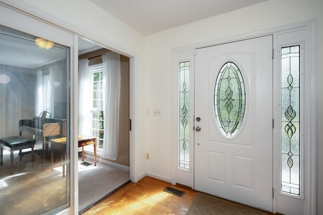 foyer entrance with hardwood / wood-style flooring