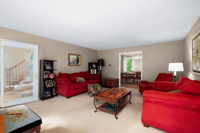 living room with a notable chandelier and carpet