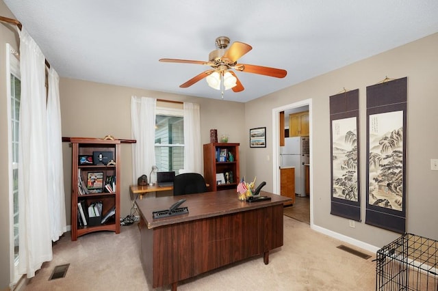 home office featuring ceiling fan and light colored carpet