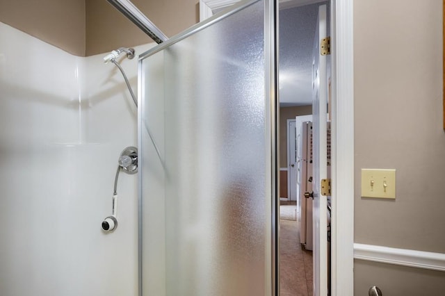 bathroom featuring a shower with door