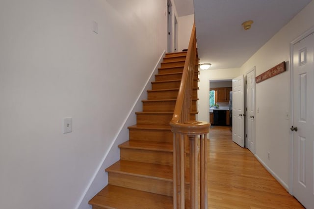 stairs featuring hardwood / wood-style flooring