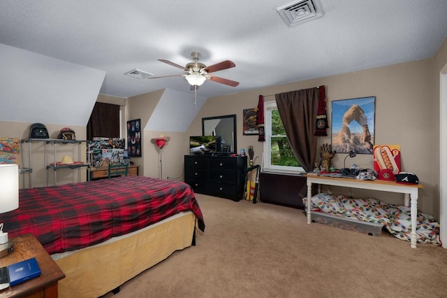 bedroom featuring light carpet, lofted ceiling, ceiling fan, and a textured ceiling