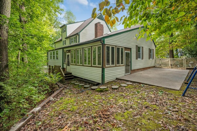 back of house with a sunroom and a patio area