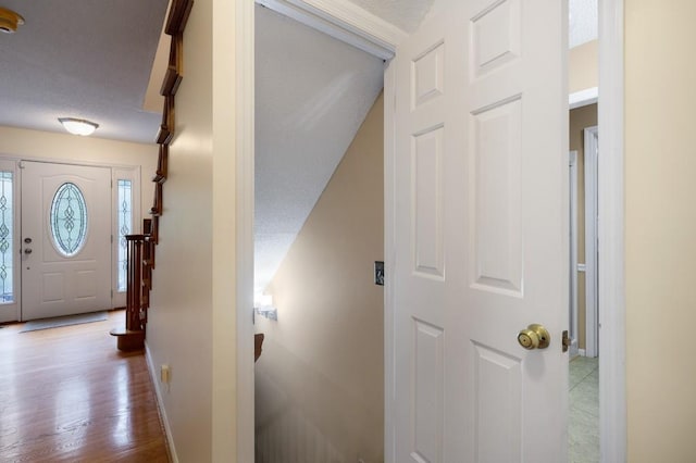 entryway with a textured ceiling and hardwood / wood-style floors