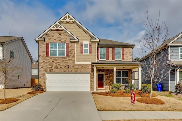 view of front of house featuring a garage, concrete driveway, and brick siding