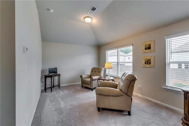 sitting room featuring lofted ceiling, baseboards, visible vents, and carpet flooring