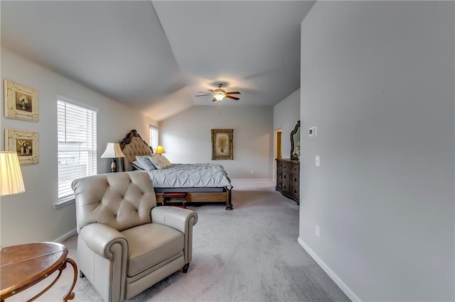 bedroom with light carpet, ceiling fan, baseboards, and lofted ceiling