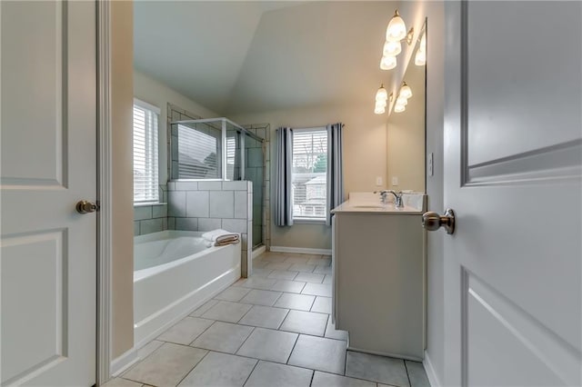 full bath featuring vanity, vaulted ceiling, a shower stall, a bath, and tile patterned floors