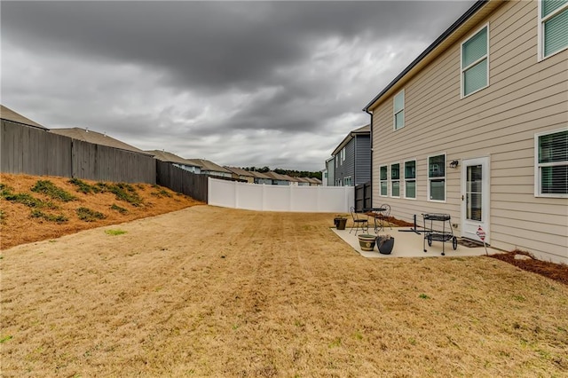 view of yard featuring a patio area and a fenced backyard