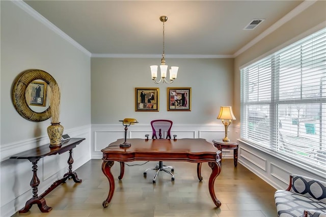 office space with ornamental molding, wood finished floors, visible vents, and a notable chandelier