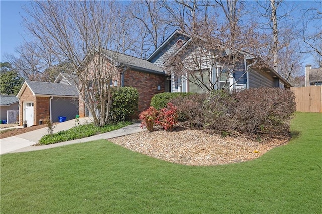 ranch-style house featuring a garage, brick siding, a front yard, and fence