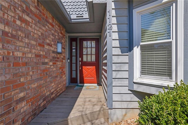 entrance to property with brick siding