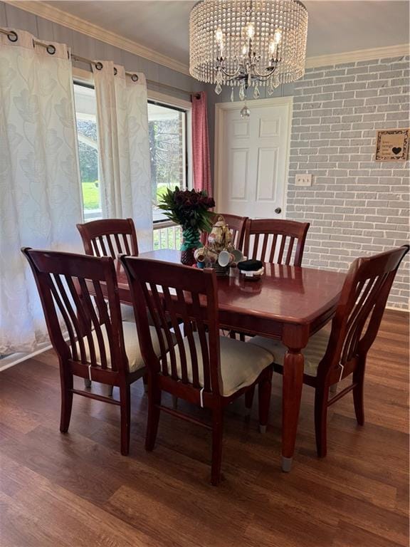 dining area featuring dark hardwood / wood-style floors, crown molding, a notable chandelier, and brick wall