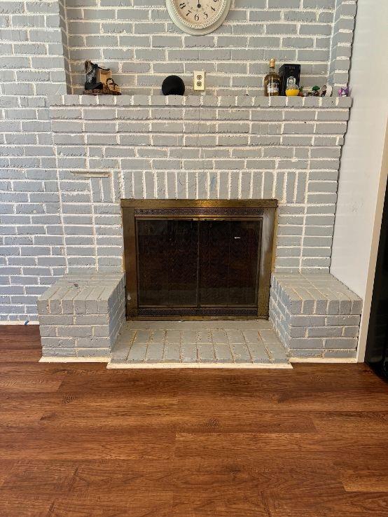 interior details featuring a fireplace and hardwood / wood-style flooring