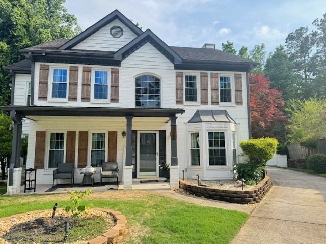 710 Oxford Crest Ct, Lawrenceville, GA 30043 - view of front of property with a porch and a front yard