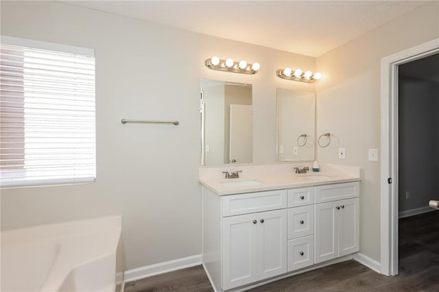 bathroom featuring vanity, a bathtub, and hardwood / wood-style flooring